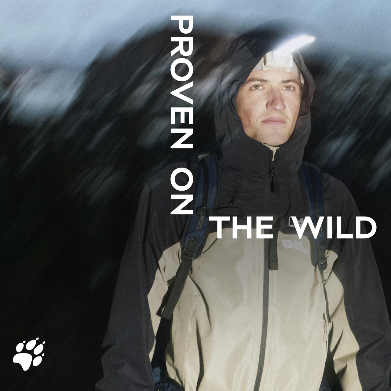 Eine Person in einer Kapuzenjacke steht nachts im Freien und trägt eine Stirnlampe. Der Text lautet „Proven on the Wild“